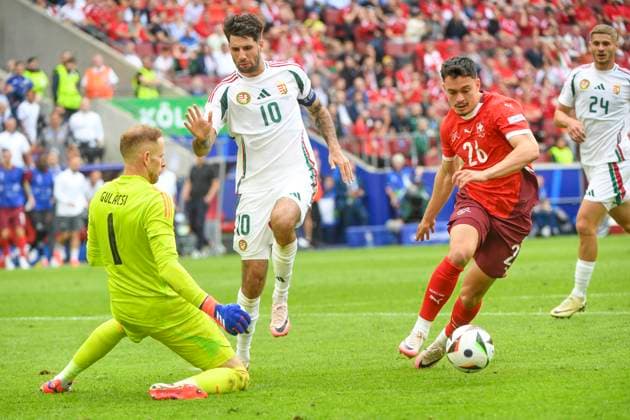 COLOGNE, GERMANY - JUNE 15: Fabian Rieder of Switzerland (R) against Dominik Szoboszlai of Hungary (C) and goalkeeper Peter Gulacsi of Hungary (L) during the UEFA EURO, EM, Europameisterschaft,Fussball 2024 group stage match between Hungary and Switzerland at Cologne Stadium on June 15, 2024 in Cologne, Germany. Cologne Cologne Stadium North Rhine-Westphalia Germany Copyright: xJustPictures.ch ManuelxWinterbergerx jp-en-EuSpIm-MWI_7899