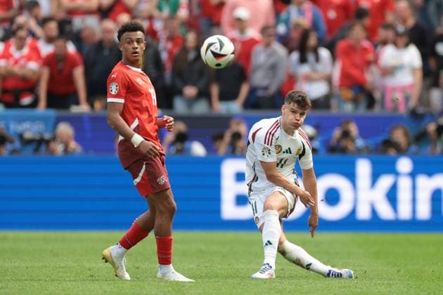 Cologne, Germany, 15th June 2024. Dan Ndoye of Switzerland looks on as Milos Kerkez of Hungary passes the ball during the UEFA European Championships match at Cologne Stadium, Cologne. Picture credit should read: Jonathan Moscrop Sportimage EDITORIAL USE ONLY. No use with unauthorised audio, video, data, fixture lists, club league logos or live services. Online in-match use limited to 120 images, no video emulation. No use in betting, games or single club league player publications. SPI-3181-0021