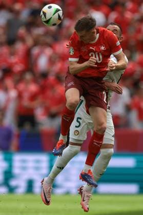 Cologne, Germany, 15th June 2024. Michel Aebischer of Switzerland heads away from Attila Fiola of Hungary during the UEFA European Championships match at Cologne Stadium, Cologne. Picture credit should read: Jonathan Moscrop Sportimage EDITORIAL USE ONLY. No use with unauthorised audio, video, data, fixture lists, club league logos or live services. Online in-match use limited to 120 images, no video emulation. No use in betting, games or single club league player publications. SPI-3181-0050