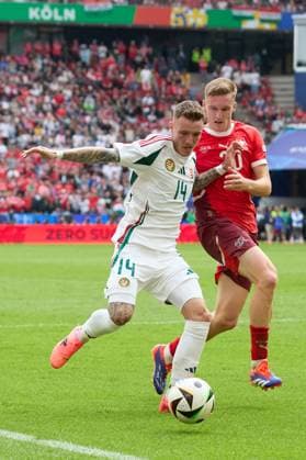 (240615) -- COLOGNE, June 15, 2024 -- Bendeguz Bolla (L) of Hungary vies with Michel Aebischer of Switzerland during the UEFA EURO, EM, Europameisterschaft,Fussball 2024 Group A match between Hungary and Switzerland in Cologne, Germany, June 15, 2024. ) (SP)GERMANY-COLOGNE-FOOTBALL-EURO 2024-SWITZERLAND VS HUNGARY MengxDingbo 