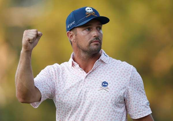 Bryson DeChambeau acknowledges fans as he walks to the eighteenth fairway during the third round of the 124th U.S. Open golf championship at Pinehurst Resort & Country Club in Pinehurst, N.C. on Saturday, June 15, 2024.  NCP20240615371 JOHNxANGELILLO