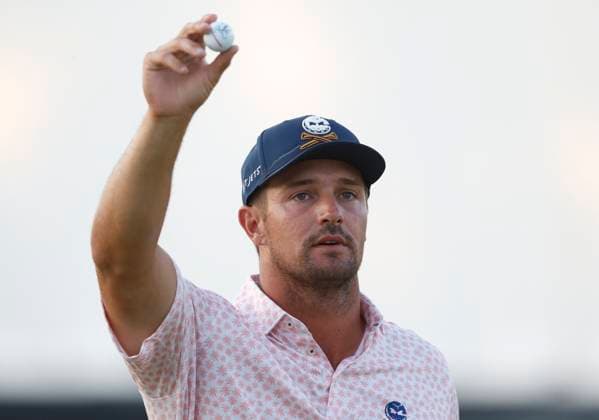 Bryson DeChambeau throws an autographed ball to the crowd on the eighteenth hole during the third round of the 124th U.S. Open golf championship at Pinehurst Resort & Country Club in Pinehurst, N.C. on Saturday, June 15, 2024. DeChambeau finished the day in the lead at 7-under-par.  NCP20240615373 JOHNxANGELILLO