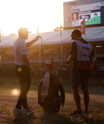 Bryson DeChambeau and caddie Gregory Bodine wait before hitting the second shot to the eighteenth green during the third round of the 124th U.S. Open golf championship at Pinehurst Resort & Country Club in Pinehurst, N.C. on Saturday, June 15, 2024. DeChambeau finished the day in the lead at 7-under-par.  NCP20240615402 JOHNxANGELILLO