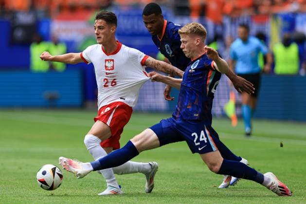 Kacper Urbanski of Poland is pulled back by Jerdy Schouten of The Netherlands Poland v Netherlands, UEFA European Championship, EM, Europameisterschaft 2024, Group D, Football, Volksparkstadion, Hamburg, Germany, 16 Jun 2024 EDITORIAL USE ONLY No use with unauthorised audio, video, data, fixture lists, club league logos or live services. Online in-match use limited to 120 images, no video emulation. No use in betting, games or single club league player publications. Copyright: xMattxWest Shutterstockx 14539367by