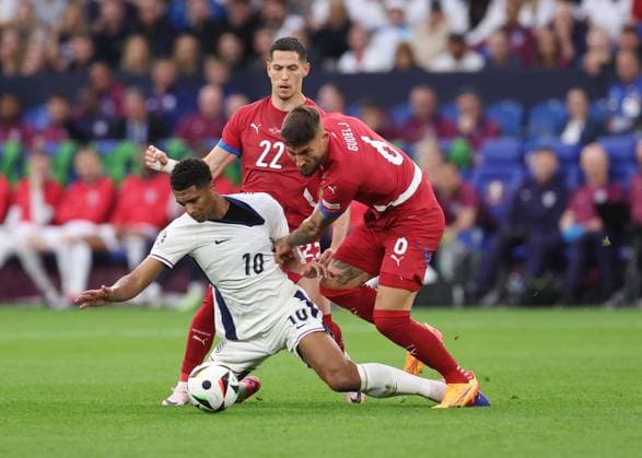Gelsenkirchen, Germany, 16th June 2024. Jude Bellingham of England tackled by Nemanja Gudelj of Serbia during the UEFA European Championships match at Arena Aufschalke, Gelsenkirchen. Picture credit should read: David Klein Sportimage EDITORIAL USE ONLY. No use with unauthorised audio, video, data, fixture lists, club league logos or live services. Online in-match use limited to 120 images, no video emulation. No use in betting, games or single club league player publications. SPI-3196-0027