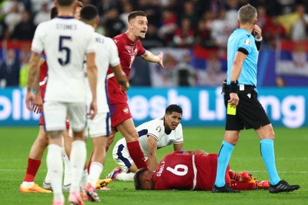 Serbia v England 16 June 2024, Gelsenkirchen - UEFA EURO, EM, Europameisterschaft,Fussball 2024 - Group C - Serbia v England - Jude Bellingham of England looks concerned but the referee issues a yellow card to Nemanja Gudelj of Serbia - Photo: Charlotte Wilson Offside. Gelsenkirchen Germany Copyright: xCharlottexWilsonx xOffsidexOffside