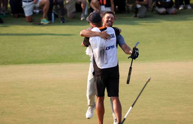 Bryson DeChambeau of the United States hugs his caddie after winning the 124th US Open golf championship at Pinehurst Resort & Country Club in Pinehurst, N.C. on Sunday, June 16, 2024.  NCP20240616808 VeaseyxConway