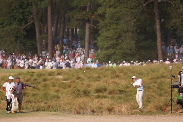 Rory McIlroy of Northern Ireland swings from the native area toward 18th hole during the final round of the 124th US Open golf championship at Pinehurst Resort & Country Club in Pinehurst, N.C. on Sunday, June 16, 2024.  NCP20240616828 VeaseyxConway