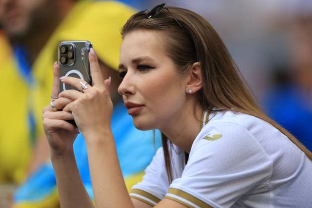 17th June 2024; Munich Football Arena, Munich, Germany; Euro 2024 Group E Football, Romania versus Ukraine; Ukraine fan takes pictures from the stands  ActionPlus12655672 PierrexTeyssot