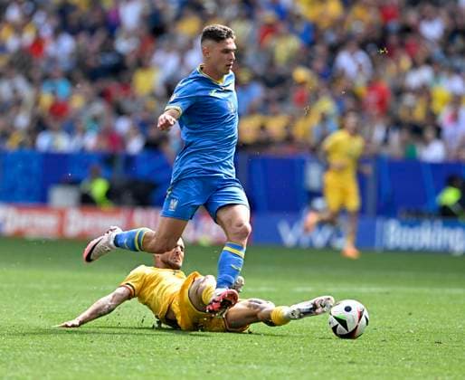 17.06.2024, Fussball UEFA EURO, EM, Europameisterschaft,Fussball 2024, Vorrunde, Match 10, Rumänien - Ukraine, in der Fußball Arena München. v.l. Georgiy Sudakov (Ukraine) gegen Darius Olaru (Rumänien)