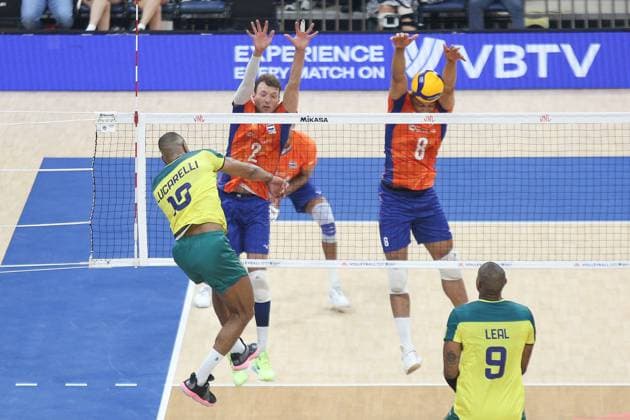 PH: Brazil Outlasts Netherlands in Four Sets during VNL 2024 Match Ricardo Lucarelli Souza 18, Yellow of Brasil spikes the ball over Wessel Keemink 2, Orange and Fabian Plak 8, Orange of the Netherlands. Pasay City Metro Manila Philippines Copyright: DennisxJeromexAcosta