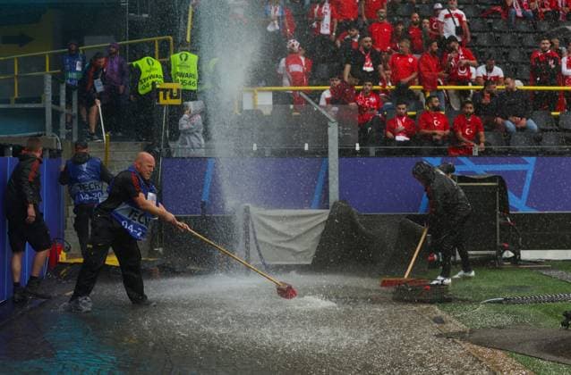 Groundstaff sweep away a flooded area after heavy rain Turkiye v Georgia, UEFA European Championship, EM, Europameisterschaft 2024, Group F, Football, BVB Stadion, Dortmund, Germany, 18 Jun 2024 EDITORIAL USE ONLY No use with unauthorised audio, video, data, fixture lists, club league logos or live services. Online in-match use limited to 120 images, no video emulation. No use in betting, games or single club league player publications.  Copyright: xPaulxCurrie Shutterstockx 14543470ai