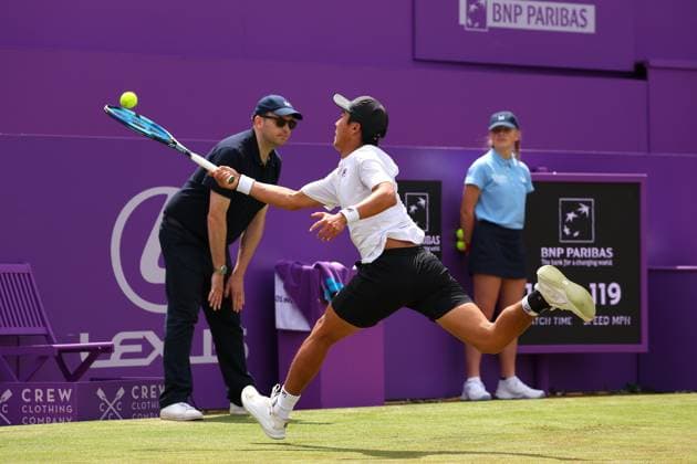 19th June 2024; Cinch Championships, Queens Club, West Kensington, London, England: Cinch Championships Queens Club, Day 3; Rinky Hijikata (AUS) attempting an overhead shot to Matteo Arnaldi (ITA), mens singles match  ActionPlus12656786 JohnxPatrickxFletcher