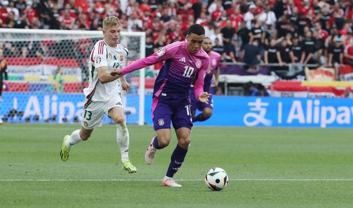 Andras Schäfer , Jamal Musiala Zweikampf Spielszene Aktion Fußball Fussball Europameisterschaft Euro 2024 EM Herren Saison 2023 2024 19.06.2024 Deutschland GER vs. Ungarn HUN in Stuttgart DFL regulations prohibit any use of photographs as image sequences and or quasi-video.