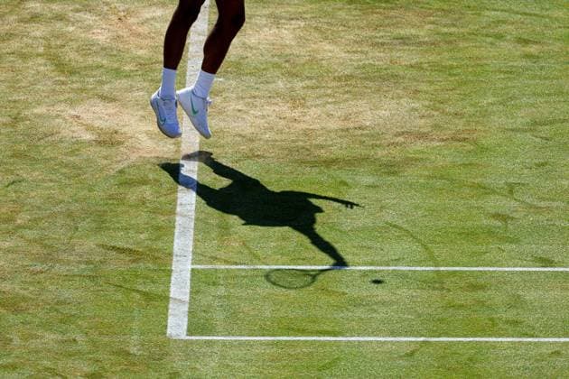 20th June 2024; Cinch Championships, Queens Club, West Kensington, London, England: Cinch Championships Queens Club, Day 4; Shadow of Mpetshi Perricard (FRA) serves to Billy Harris (GBR), mens singles match  ActionPlus12657402 JohnxPatrickxFletcher