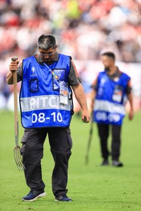 Football - UEFA EURO, EM, Europameisterschaft,Fussball 2024 - Group C - Denmark v England 20th June 2024 - UEFA EURO 2024 - Group C - Denmark v England - The groundsman holds a chuck on the pitch in his hand - Photo: Simon Stacpoole Offside. Frankfurt Germany Copyright: xSimonxStacpoolexOffside