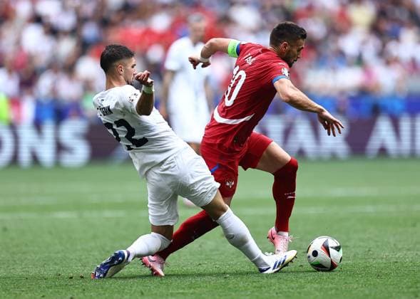 Dusan Tadic of Serbia is challenged by Adam Gnezda Cerin of Slovenia Slovenia v Serbia, UEFA European Championship, EM, Europameisterschaft 2024, Group C, Football, Munich Football Arena, Munich, Germany, 20 Jun 2024 EDITORIAL USE ONLY No use with unauthorised audio, video, data, fixture lists, club league logos or live services. Online in-match use limited to 120 images, no video emulation. No use in betting, games or single club league player publications. Copyright: xMichaelxZemanek Shutterstockx 14543659fw