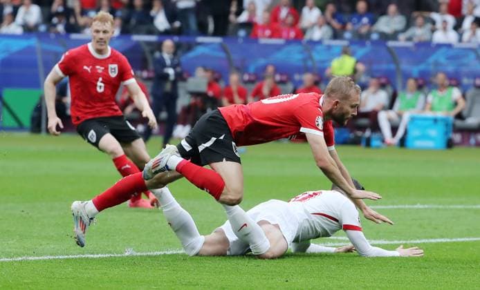 Konrad Laimer im Zweikampf mit Piotr Zielinski Fußball Fussball Europameisterschaft Euro 2024 EM Herren Saison 2023 2024 21.06.2024 Polen POL vs. Österreich AUT in Berlin DFL regulations prohibit any use of photographs as image sequences and or quasi-video.