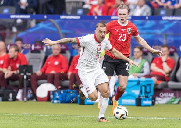 21st June 2024; Olympiastadion, Berlin, Germany; Euro 2024 Group D Football, Poland versus Austria; Kamil Grosicki (POL) breaks away from Patrick Wimmer (AUT)  ActionPlus12658329 FotoxOlimpik