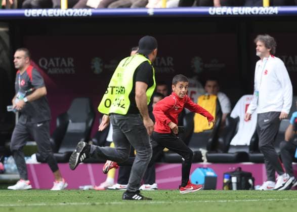 Dortmund, Germany, 22nd June 2024. A young fan runs onto the pitch for a selfie with Cristiano Ronaldo of Portugal before being chased by stewards during the UEFA European Championships match at BVB Stadion, Dortmund. Picture credit should read: David Klein Sportimage EDITORIAL USE ONLY. No use with unauthorised audio, video, data, fixture lists, club league logos or live services. Online in-match use limited to 120 images, no video emulation. No use in betting, games or single club league player publications. SPI-3202-0088