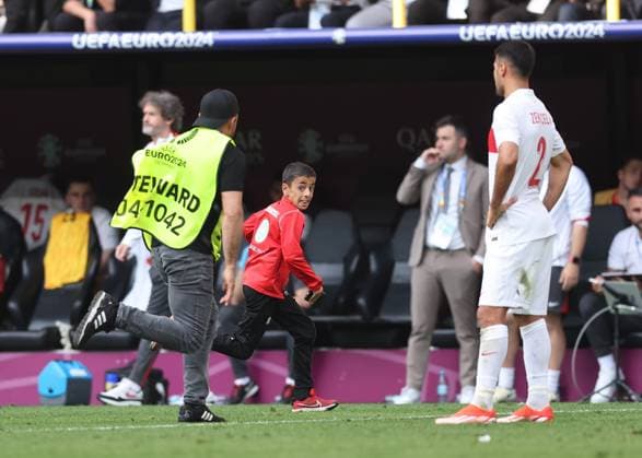 Dortmund, Germany, 22nd June 2024. A young fan runs onto the pitch for a selfie with Cristiano Ronaldo of Portugal before being chased by stewards during the UEFA European Championships match at BVB Stadion, Dortmund. Picture credit should read: David Klein Sportimage EDITORIAL USE ONLY. No use with unauthorised audio, video, data, fixture lists, club league logos or live services. Online in-match use limited to 120 images, no video emulation. No use in betting, games or single club league player publications. SPI-3202-0089