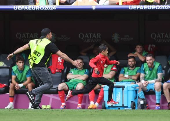 Dortmund, Germany, 22nd June 2024. A young fan runs onto the pitch for a selfie with Cristiano Ronaldo of Portugal before being chased by stewards during the UEFA European Championships match at BVB Stadion, Dortmund. Picture credit should read: David Klein Sportimage EDITORIAL USE ONLY. No use with unauthorised audio, video, data, fixture lists, club league logos or live services. Online in-match use limited to 120 images, no video emulation. No use in betting, games or single club league player publications. SPI-3202-0090
