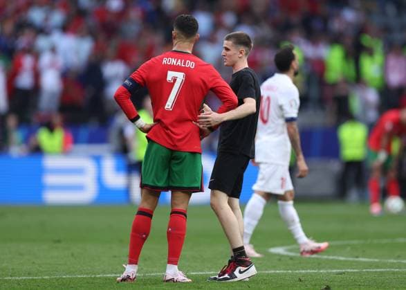Dortmund, Germany, 22nd June 2024. A second fan runs onto the pitch to try and take selfie with Cristiano Ronaldo of Portugal during the UEFA European Championships match at BVB Stadion, Dortmund. Picture credit should read: David Klein Sportimage EDITORIAL USE ONLY. No use with unauthorised audio, video, data, fixture lists, club league logos or live services. Online in-match use limited to 120 images, no video emulation. No use in betting, games or single club league player publications. SPI-3202-0105