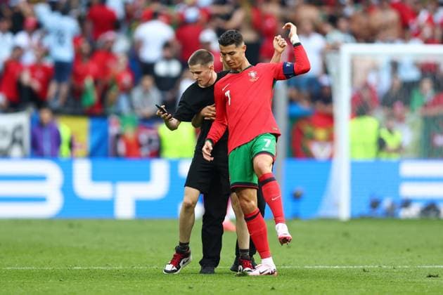 Turkey v Portugal 22 June 2024, Dortmund - UEFA EUROs - Group F - Turkey v Portugal - A pitch-invader fan tries to get a selfie with Cristiano Ronaldo of Portugal who shrugs him off - Photo: Charlotte Wilson Offside. Dortmund Germany Copyright: xCharlottexWilsonx xOffsidexOffside