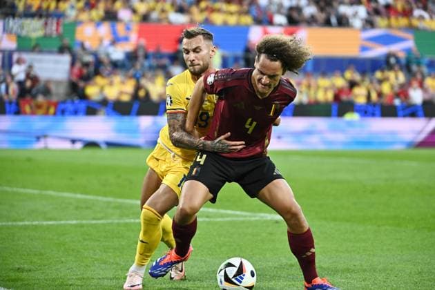 240622 EURO2024 BELGIUM VS ROMANIA Denis DraguÅü (19) of Romania battles for the ball with Wout Faes (4) of Belgium during a soccer game between the national teams of Belgium, called the Red Devils and Romania on the second matchday in Group E in the group stage of the UEFA EURO, EM, Europameisterschaft,Fussball 2024 tournament , on Saturday 22 June 2024 in Cologne , Germany . PHOTO Isosport Maarten Straetemans Cologne GERMANY  Copyright: xx 466873