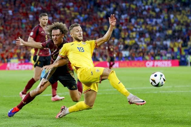 COLOGNE, RheinEnergieStadium , 22-06-2024 , European Football Championship Euro2024, Group stage match no.22 between Belgium and Romania. Belgium player Wout Faes and Romania player Denis Mihai Dragus Belgium - Romania (Euro2024)  x25568078x Copyright: