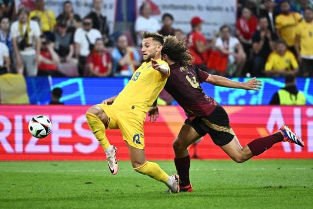 240622 EURO2024 BELGIUM VS ROMANIA Denis DraguÅü (19) of Romania battles for the ball with Wout Faes (4) of Belgium during a soccer game between the national teams of Belgium, called the Red Devils and Romania on the second matchday in Group E in the group stage of the UEFA EURO, EM, Europameisterschaft,Fussball 2024 tournament , on Saturday 22 June 2024 in Cologne , Germany . PHOTO Isosport Maarten Straetemans Cologne GERMANY  Copyright: xx 466926