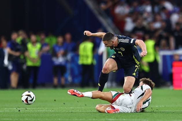 John McGinn of Scotland is fouled by Callum Styles of Hungary Scotland v Hungary, UEFA European Championship, EM, Europameisterschaft 2024, Group A, Football, Stuttgart Arena, Stuttgart, Germany, 23 Jun 2024 EDITORIAL USE ONLY No use with unauthorised audio, video, data, fixture lists, club league logos or live services. Online in-match use limited to 120 images, no video emulation. No use in betting, games or single club league player publications. Copyright: xMichaelxZemanek Shutterstockx 14548075y