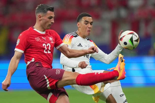 Germany s Jamal Musiala fight for the ball with Switzerland s Fabian Schar during the Euro 2024 soccer match between Switzerland and Germany at the Frankfurt Arena , Frankfurt , Germany - Sunday 23 June 2024. - Soccer .  Copyright: xSpada LaPressex