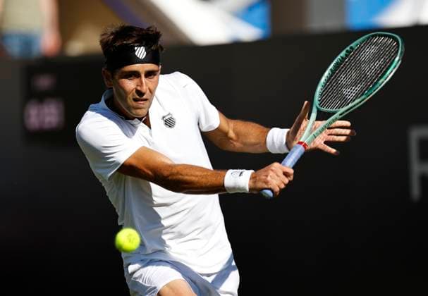 24th June 2024; Devonshire Park, Eastbourne, East Sussex, England: Rothesay International Eastbourne, Day 1; Tomas Martin Etchverry (ARG) plays a backhand against Juncheng Shang (CHN)  ActionPlus12660040 HongboxChen