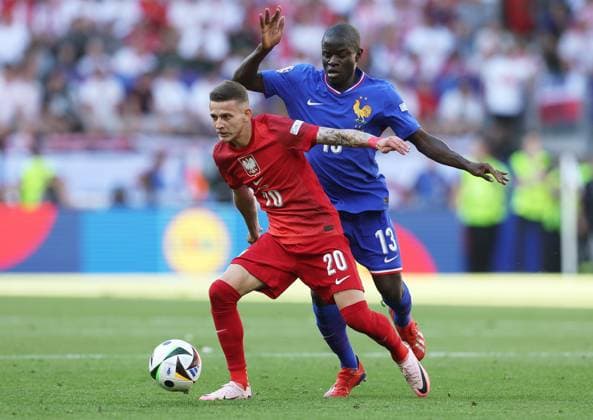Sebastian Szymanski of Poland is challenged by Ngolo Kantà of France France v Poland, UEFA European Championship, EM, Europameisterschaft 2024, Group D, Football, BVB Stadion, Dortmund, Germany, 25 Jun 2024 EDITORIAL USE ONLY No use with unauthorised audio, video, data, fixture lists, club league logos or live services. Online in-match use limited to 120 images, no video emulation. No use in betting, games or single club league player publications. Copyright: xPaulxCurrie Shutterstockx 14555523bo