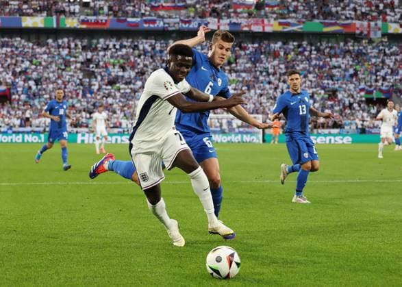 Cologne, Germany, 25th June 2024. Bukayo Saka of England tussles with Jaka Bijol of Slovenia during the UEFA European Championships match at Cologne Stadium, Cologne. Picture credit should read: David Klein Sportimage EDITORIAL USE ONLY. No use with unauthorised audio, video, data, fixture lists, club league logos or live services. Online in-match use limited to 120 images, no video emulation. No use in betting, games or single club league player publications. SPI-3205-0036
