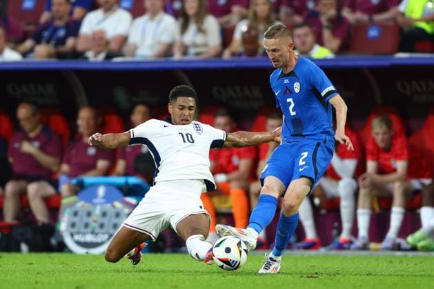 Jude Bellingham of England and Zan Karnicnik of Slovenia England v Slovenia, UEFA European Championship, EM, Europameisterschaft 2024, Group C, Football, Cologne Stadium, Cologne, Germany, 25 Jun 2024 EDITORIAL USE ONLY No use with unauthorised audio, video, data, fixture lists, club league logos or live services. Online in-match use limited to 120 images, no video emulation. No use in betting, games or single club league player publications. Copyright: xKieranxMcManus Shutterstockx 14555526bt