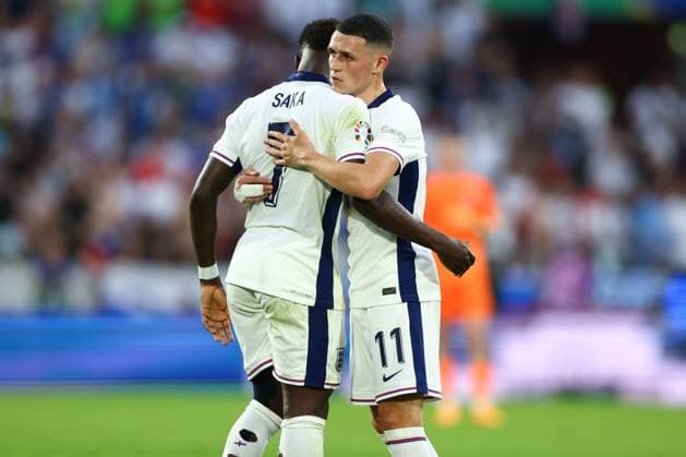Phil Foden of England embraces Bukayo Saka of England England v Slovenia, UEFA European Championship, EM, Europameisterschaft 2024, Group C, Football, Cologne Stadium, Cologne, Germany, 25 Jun 2024 EDITORIAL USE ONLY No use with unauthorised audio, video, data, fixture lists, club league logos or live services. Online in-match use limited to 120 images, no video emulation. No use in betting, games or single club league player publications. Copyright: xKieranxMcManus Shutterstockx 14555526by
