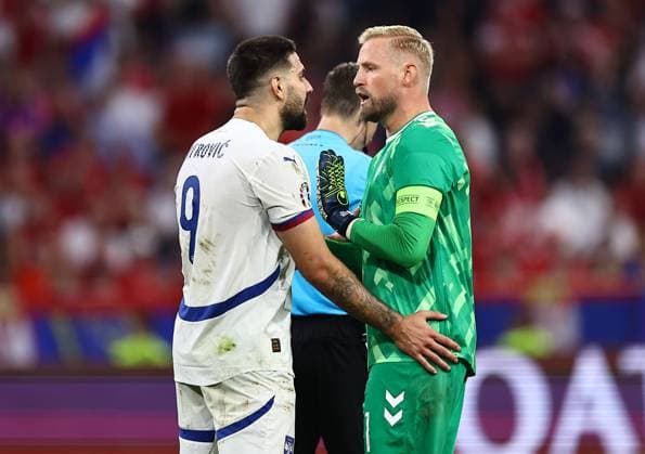 Aleksandar Mitrovic of Serbia speaks with Kasper Schmeichel of Denmark Denmark v Serbia, UEFA European Championship, EM, Europameisterschaft 2024, Group C, Football, Munich Football Arena, Munich, Germany, 25 Jun 2024 EDITORIAL USE ONLY No use with unauthorised audio, video, data, fixture lists, club league logos or live services. Online in-match use limited to 120 images, no video emulation. No use in betting, games or single club league player publications. Copyright: xMichaelxZemanek Shutterstockx 14555536cv