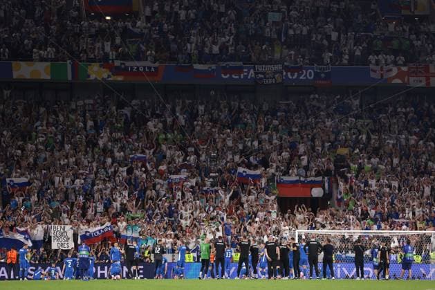 Cologne, Germany, 25th June 2024. Slovenia staff and players celebrate in front of fans following the final whistle of the UEFA European Championships match at Cologne Stadium, Cologne. Picture credit should read: Jonathan Moscrop Sportimage EDITORIAL USE ONLY. No use with unauthorised audio, video, data, fixture lists, club league logos or live services. Online in-match use limited to 120 images, no video emulation. No use in betting, games or single club league player publications. SPI-3191-0054