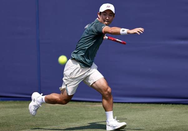 26th June 2024; Devonshire Park, Eastbourne, East Sussex, England: Rothesay International Eastbourne, Day 3; Yoshihito Nishioka (JPN) plays a forehand against Marcos Giron (USA) , mens singles match  ActionPlus12660712 HongboxChen