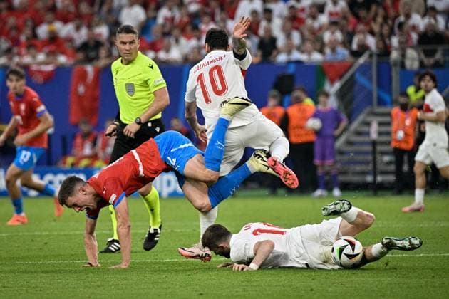 From left Czech Lukas Provod, Hakan Calhanoglu, Ismail Yuksek both of Turkey in action during the Group F match of the European Football Championship: Turkey vs Czechia, in Hamburg, Germany, on June 26, 2024. (CTKxPhoto VitxSimanek) CTKPhotoP2024062609583  CTKPhotoP2024062609583