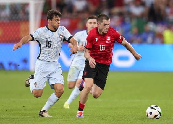 Football - 2024 UEFA European Championship, EM, Europameisterschaft Finals - Group F - Gerogia vs Portugal - Arena AufSchalke, Gelsenkirchen - Wednesday 26th Junes 2024 Giorgi Chakvetadze of Georgia vies with Joao Neves of Portugal 