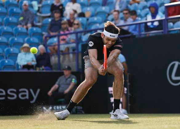 27th June 2024; Devonshire Park, Eastbourne, East Sussex, England: Rothesay International Eastbourne, Day 4; Taylor Fritz (USA) plays a backhand against Juncheng Shang (CHN) in the quarter-final match  ActionPlus12661161 HongboxChen