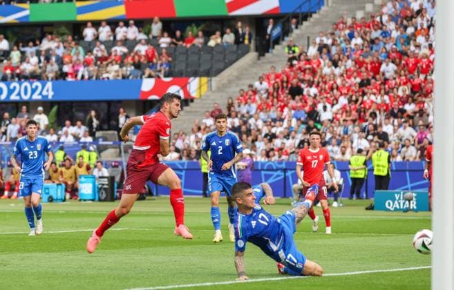 Remo Freuler of Switzerland scores the opening goal 1-0 as Gianluca Mancini of Italy blocks Switzerland v Italy, UEFA European Championship, EM, Europameisterschaft 2024, Round of 16, Football, Olympiastadion, Berlin, Germany - 29 Jun 2024 EDITORIAL USE ONLY No use with unauthorised audio, video, data, fixture lists, club league logos or live services. Online in-match use limited to 120 images, no video emulation. No use in betting, games or single club league player publications. Copyright: xPaulxCurrie Shutterstockx 14562043be