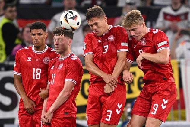 Germany Soccer Euro 2024 Germany - Denmark 8719295 29.06.2024 From left, Denmark s Alexander Bah, Andreas Skov Olsen, Jannik Vestergaard, and Rasmus Hojlund jump into the air to try to stop the ball during the UEFA EURO, EM, Europameisterschaft,Fussball 2024 Round of 16 soccer match between Germany and Denmark at the BVB Stadion Dortmund, in Dortmund, Germany. Alexey Filippov Sputnik Dortmund Germany  Copyright: xAlexeyxFilippovx