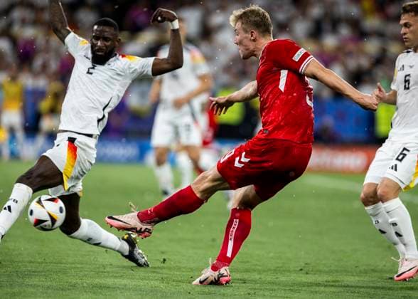 Dortmund, Signal Iduna Park, 29.06.2024: Rasmus Hoejlund of denmark kicks the ball against Antonio Ruediger of germany during the match UEFA European Championship, EM, Europameisterschaft 2024 Germany v. Denmark.