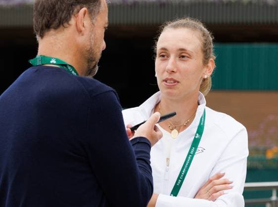 Belgian Elise Mertens is interviewed by former Belgian player Filip Dewulf prior to a training session during preparations ahead of the 2024 Wimbledon grand slam tennis tournament at the All England Tennis Club, in south-west London, Britain, Sunday 30 June 2024. BENOITxDOPPAGNE  x95551493x