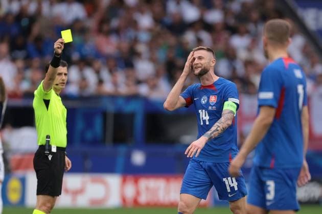 Gelsenkirchen, Germany, 30th June 2024. Milan Skriniar of Slovakia reacts as he is shown a yellow card by the Referee Halil Umut Meler of Turkey for a foul on Jude Bellingham of England during the UEFA European Championships Round of 16 match at Arena Aufschalke, Gelsenkirchen. Picture credit should read: Jonathan Moscrop Sportimage EDITORIAL USE ONLY. No use with unauthorised audio, video, data, fixture lists, club league logos or live services. Online in-match use limited to 120 images, no video emulation. No use in betting, games or single club league player publications. SPI-3209-0024