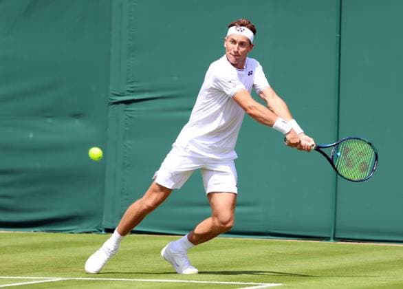 Norway s Casper Ruud plays a backhand in his first round match against Australian Alex Bolt on day one of the 2024 Wimbledon Championships in London on Monday, July 01, 2024.  LON2024070102 HUGOxPHILPOTT